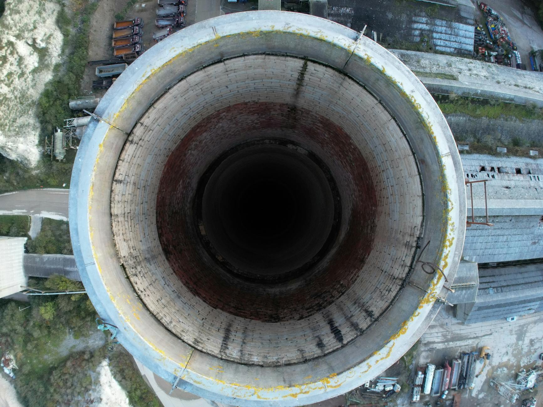 Drone shot capturing a top view of a large industrial chimney in Shoreham-by-Sea, UK.