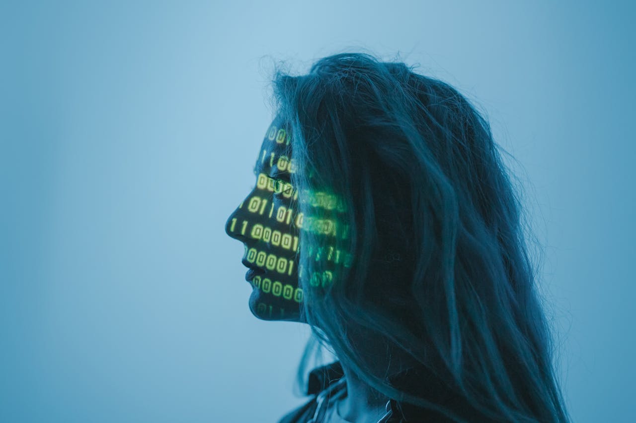 services-07 Silhouette of a woman with binary code projected on her face in a digital concept setting.
