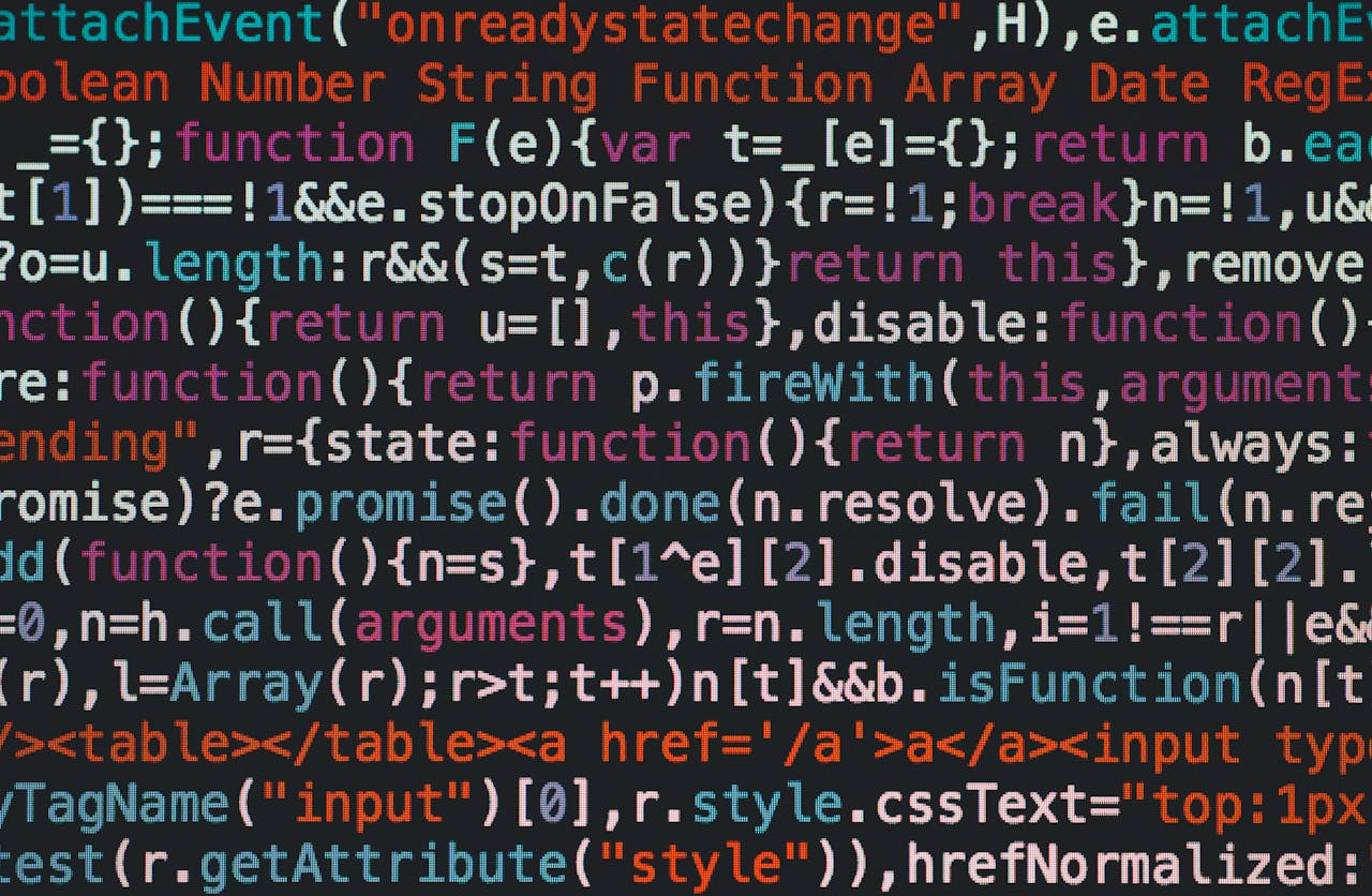 about-002 Close-up of colorful coding text on a dark computer screen, representing software development.