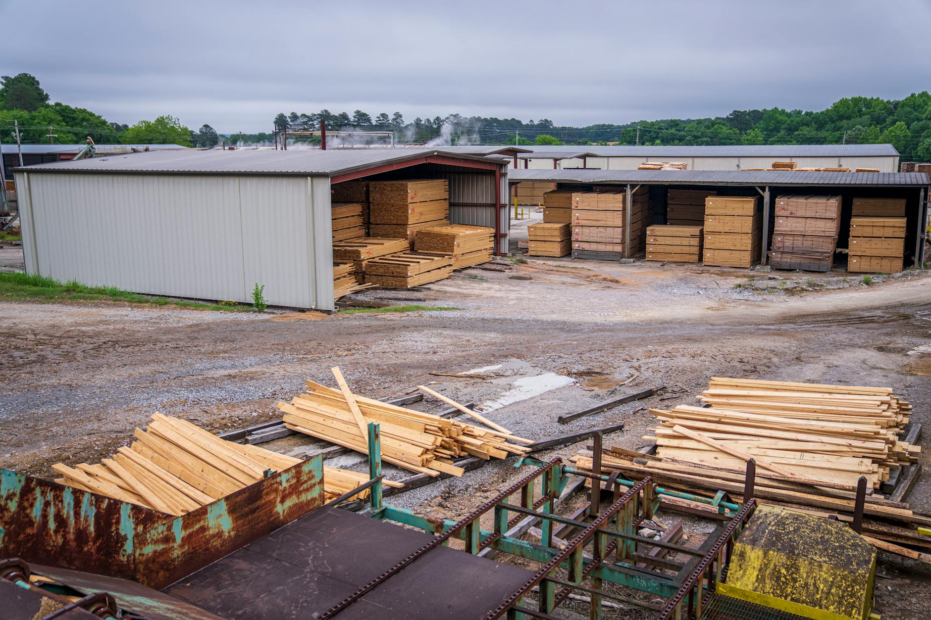 A comprehensive view of an industrial lumber yard showcasing neatly stacked wood planks ready for distribution.